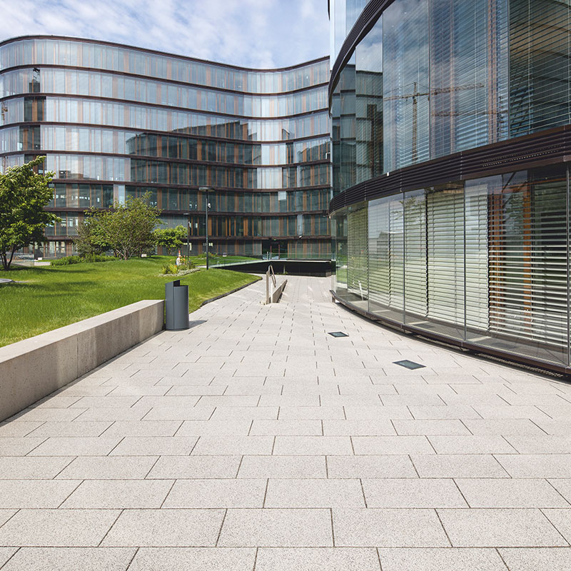 Burkolt gyalogos felület Largo burkolólap 59,8 × 29,8 × 5 cm nemeszúzalék fehér-fekete kivitelben az Erste Group/Erste Campus területén a Friedl Steinwerke termékeivel.