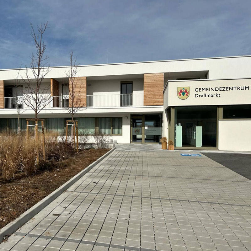 Gemeindezentrum Draßmarkt Öko Plus VG4, szürke Parkoló a draßmarkti központ előtt Öko Plus VG4 burkolattal, szürke árnyalatban, rendezett megjelenés, Friedl Steinwerke.